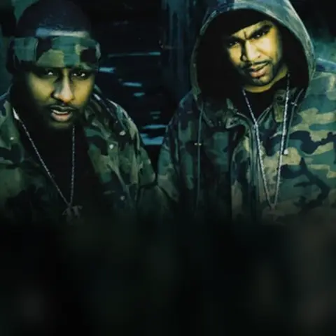 Capone and Noreaga in camouflage jackets, side by side